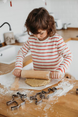 4 years cute girl making traditional Christmas cookies.