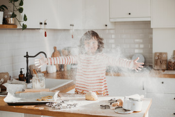 4 years cute girl making traditional Christmas cookies.