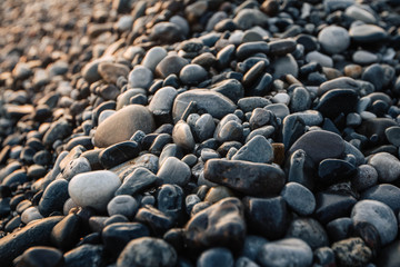 Gravel pattern of wet colored stones. Abstract nature pebbles background. Stone background. Sea peblles beach. Top view