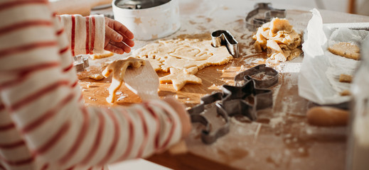 Child's hands making traditional Christmas cookies