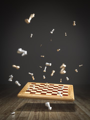 image of a chessboard falling on the wooden floor