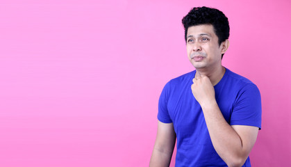Portrait Handsome Asia man There is a sore throat on pink background in studio With copy space.