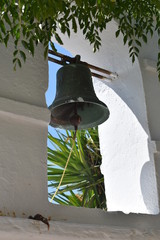 Close up view of a church bell, in a tower on the Greek holiday island of Ios.