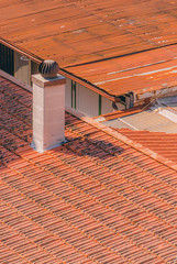 roof of a house and chimney top on red tiles