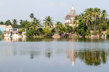 Fototapeta premium Shiva temple reflecting in a pond in Puthia village, Bangladesh