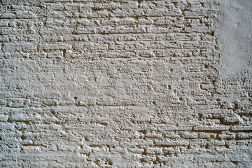 Background of old vintage white brick wall with peeling plaster, texture, background.