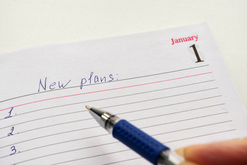 Notepad with the date of 1 January. The concept of recording plans for the new year.