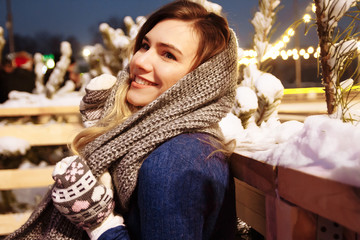 beautiful girl in winter hat near the Christmas tree, winter holidays, holiday and walks photo under a film photograph with grain