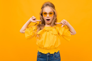 Nice little girl with her glasses smiles isolated on white background