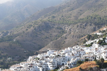 Fototapeta na wymiar A view of the pretty Spanish village of Frigiliana. Surrounded by high mountains the village is dramatically located.