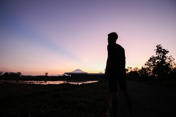 Fototapeta na wymiar silhouette of men staring at a beautiful sunset