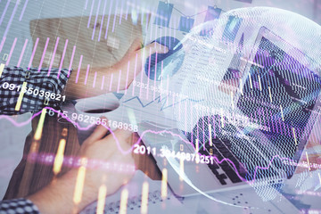 Double exposure of businessman with laptop and stock market forex chart.