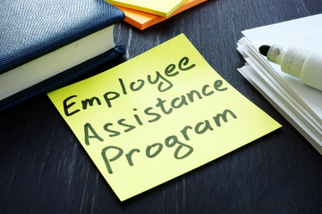 Employee assistance program EAP sign and pile of papers.