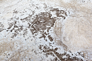 Gray dry soil salt or cracked ground texture background. Takyr