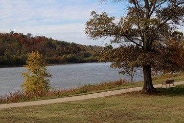 The view of the river from the grass field in the park.