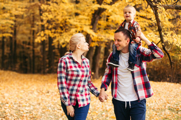 Little cute son playing with parents in forest