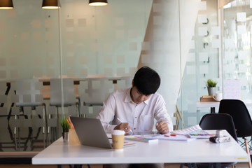 Interior designer, graphic designer, decorator creating project with stylus pen, using drawing apps on pro digital tablet with colour sample on desk in office. Man working on tablet computer, close up