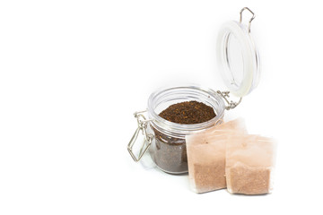 teabag and tea in a jar on a white background