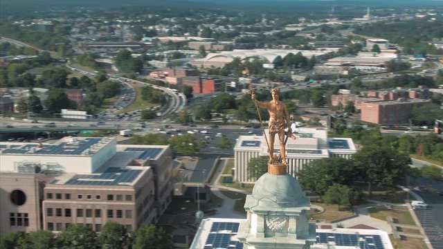 Aerial of statue on top of the  Rhode Island State House Capitol building, Providence, Rhode Island, USA. 27 August 2019