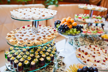 Fototapeta na wymiar Dessert table of delicious sweets on wedding reception.