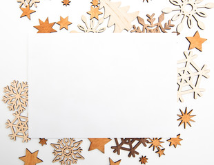 Fototapeta premium The beautiful christmas background with a lot of small wooden decorations on the white desk.