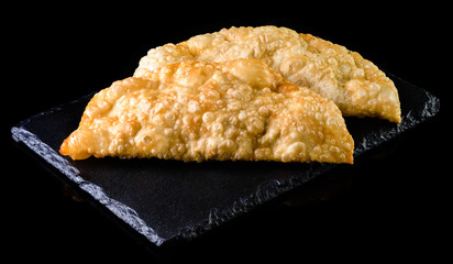 cheburek on a black background