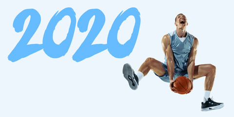 2020 Year meeting. Young caucasian basketball player in action, motion in jump isolated on blue...