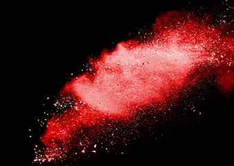 Red powder explosion on dark background. Colored cloud. Colorful dust explode. Paint Holi.