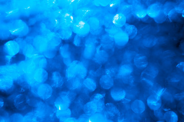 Blue background with blinking stars. Holiday abstract texture.