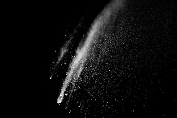 Freeze motion of white color powder exploding on dark background. 