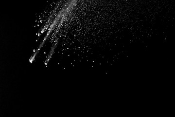 Freeze motion of white color powder exploding on dark background. 