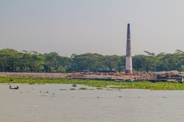KATCHA RIVER, BANGLADESH - NOVEMBER 19, 2016: Brick factory on a coast on Katcha (Kacha) river,...