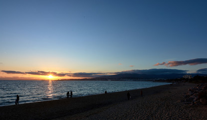 Sunset in Playa de Palma. People walking at sunset. Sunset in the sea. Seascape.