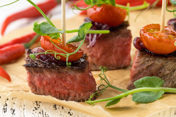 Beautifully decorated catering banquet table with assortment variety of different food snacks and appetizers on corporate christmas birthday party event or wedding celebration