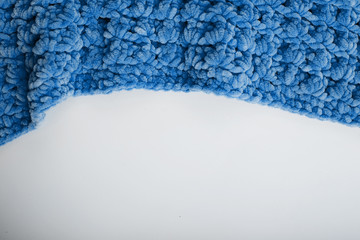 Texture of blue knit blanket. Plaid merino wool.