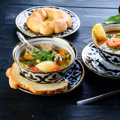 homemade shurpa soup on a black table