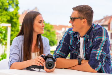 Couple of tourists traveling and exploring beautiful old town together. Loving man and woman in a vacation trip.