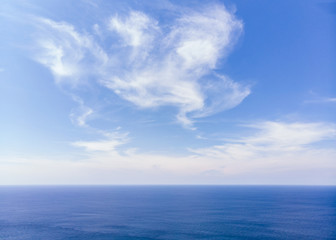 Naklejka na ściany i meble Blue sky with clouds on sea