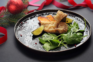 Fried carp, Fish served with sweet potato fries. Christmas dishes, traditional Christmas food. Composition of dishes on the holiday table. Horizontal culinary background.