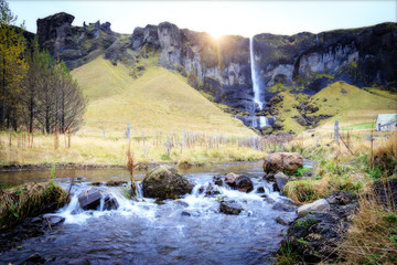 Panoramic summer view of small waterfall near Bjodvegur road. Wonderful sunrise on Iceland, Vik location. Beauty of nature concept background..