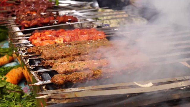 Turkish Adana kebab, ciger kebab on fire with smoke