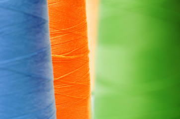 Close-up colorful spools of thread background.