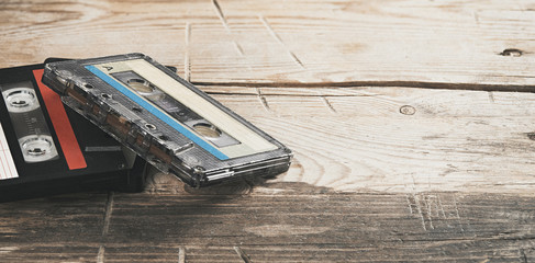 Two old audio tapes on wooden background