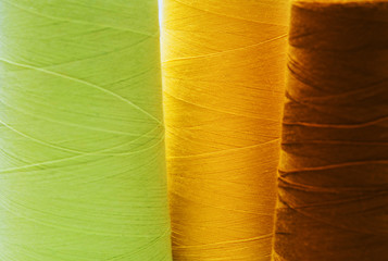 Close-up colorful spools of thread background.