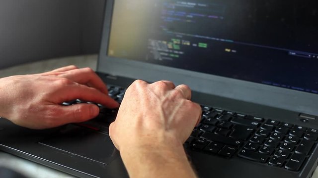 Programmer coding on laptop. Coder hands typing program code on keyboard for website. Professional developer freelance computer work process concept