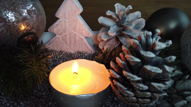 Modern grey and white Advent Christmas time table decoration with warm candle light burning, 4k video footage still
