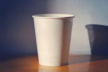 white empty cardboard Cup on wooden background