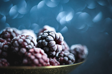 Frozen blackberries on a wooden table. Horizontal.