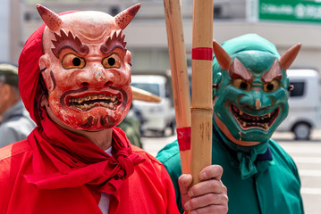 Two man wearing traditional demon masks during annual Takayama festival. Takayama, Japan