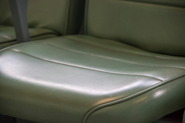 Closeup of a green leather seat in a car